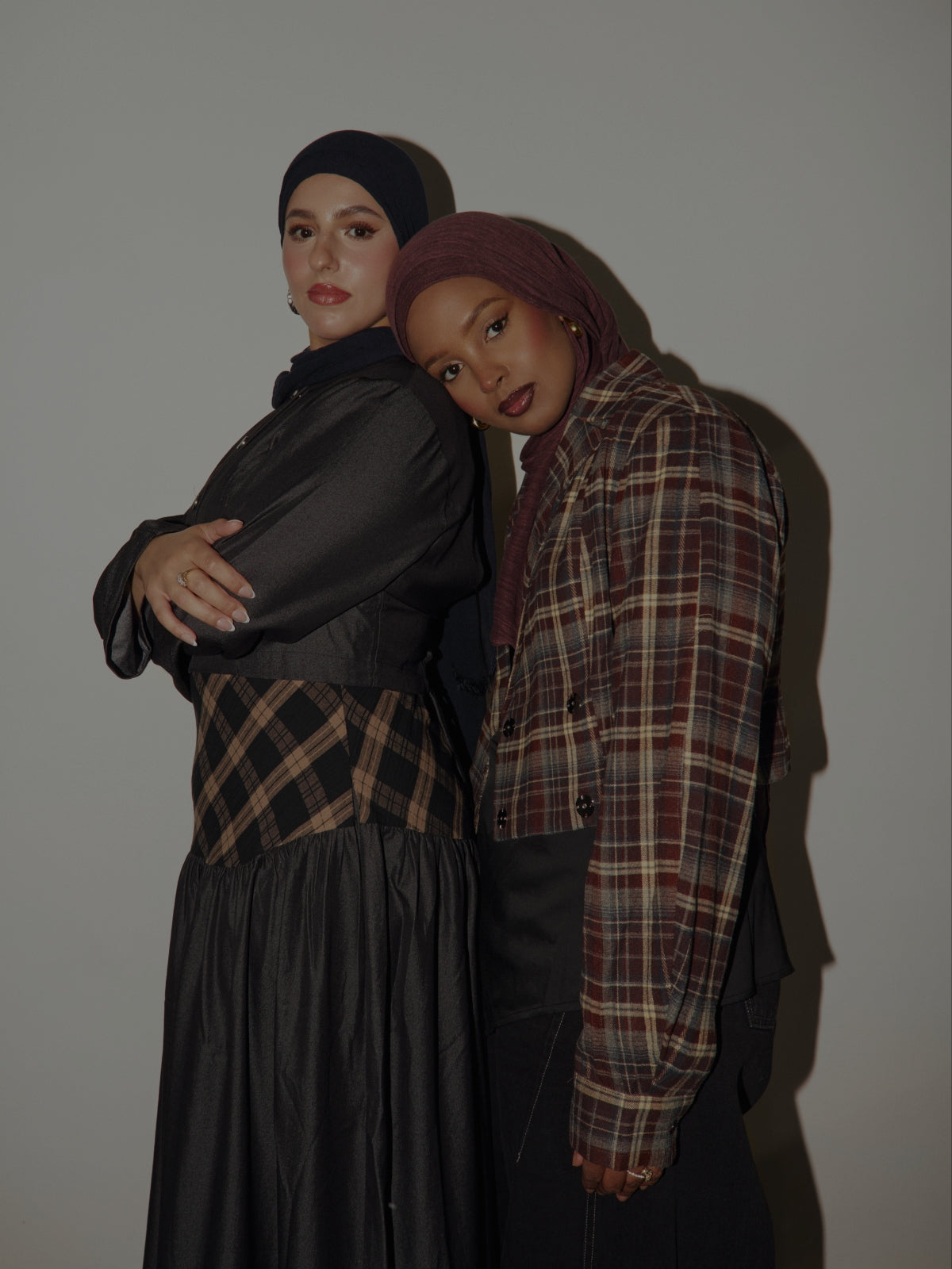 Two women in hijabs wearing VEILED new arrivals, including a plaid shirt and a plaid bias dress