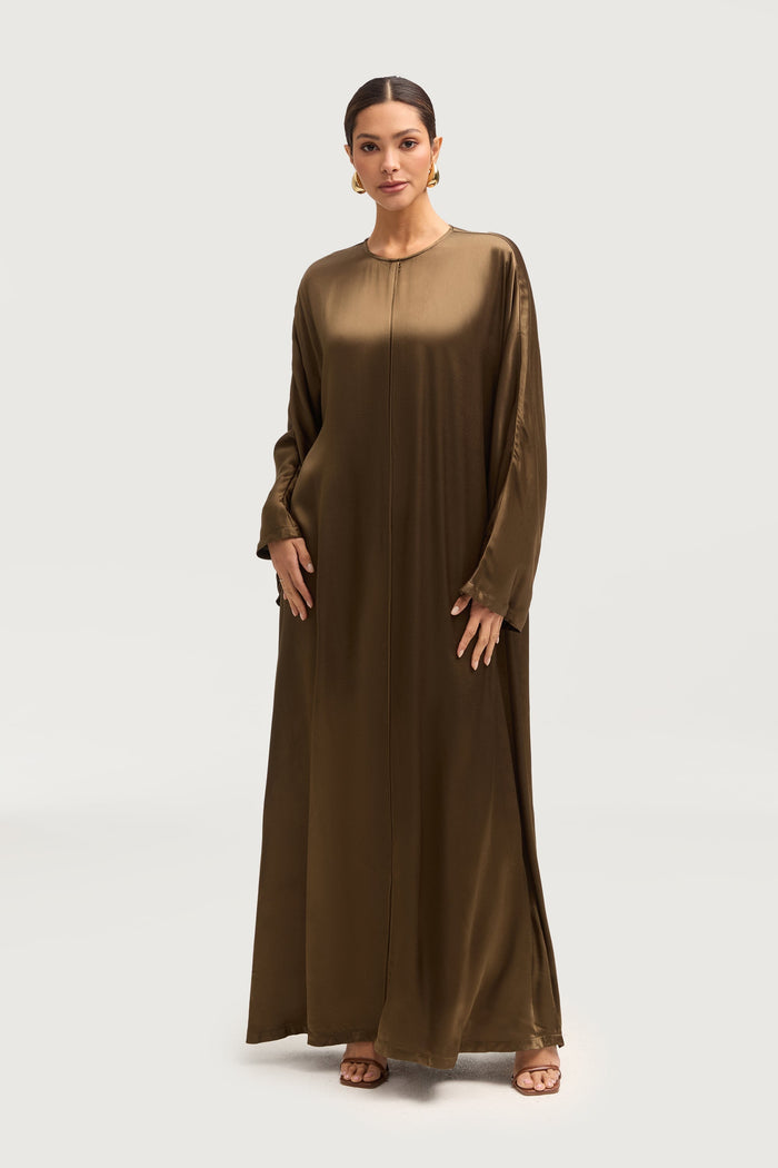 A woman wearing an olive-green abaya